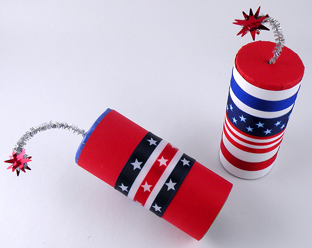 Paper tubes decorated with patriotic ribbon with silver fuses and a red star at the end of the tube