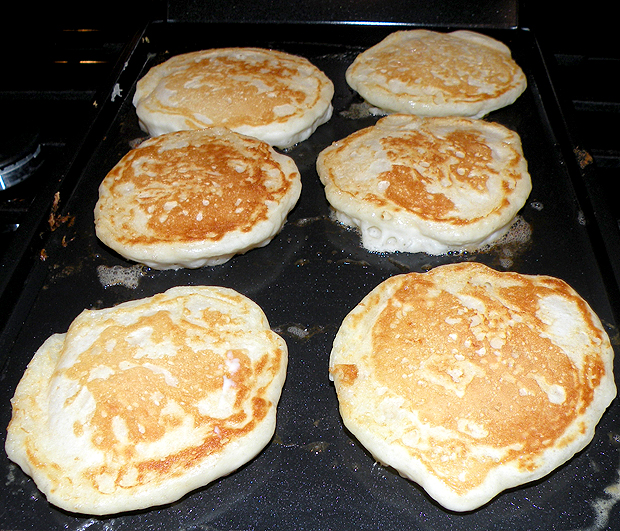Pancakes Cooking on Griddle