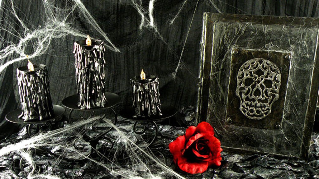black dripping halloween candles and a skull book