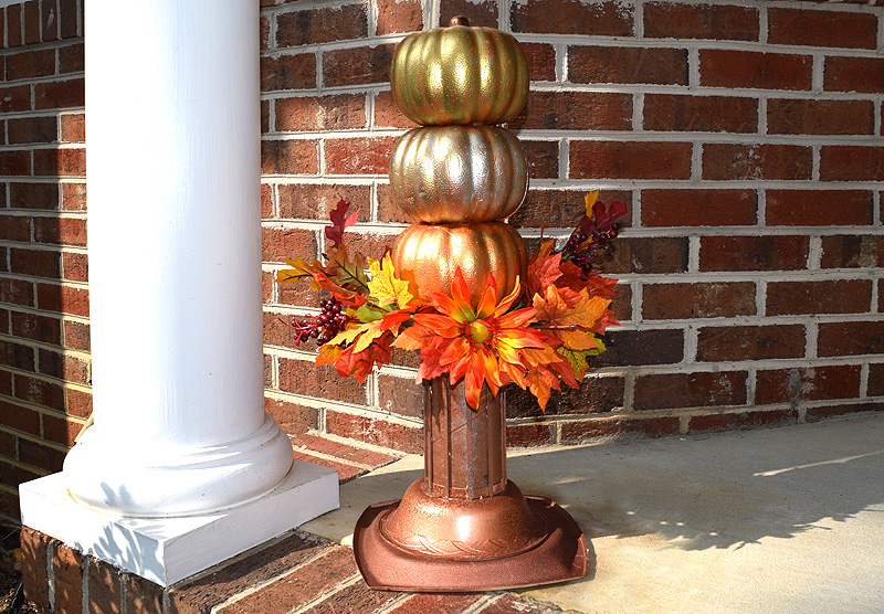 Stacked pumpkin topiary with fall leaves and flowers 