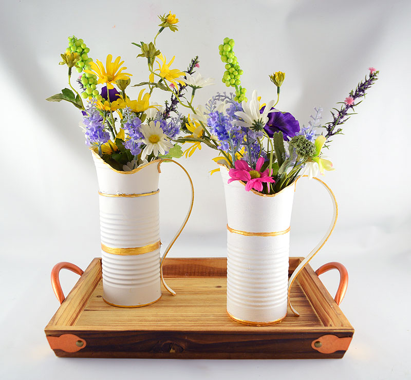 White pitcher vase with gold trim and flowers