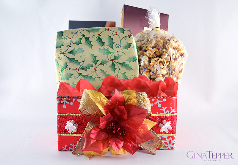 Christmas box decoratated with red wraping paper, snowflakes ribbon and filled with gifts