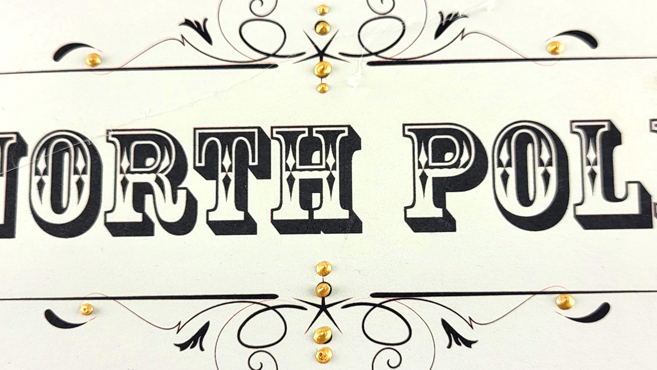 black on white North Pole Sign with gold accents