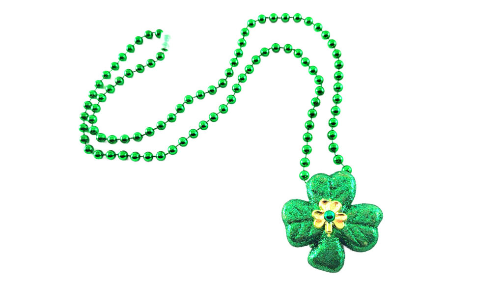 A DIY St. Patrick's Day necklace made from green Dollar Tree beads and a glittery foam shamrock scatter, featuring intricate gold 3D puffy paint swirls and a tiny gold shamrock center.
