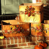Cardboard boxes painted metallic copper and accented with harvest ribbon and leaves