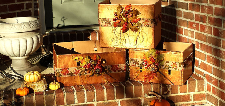 Cardboard boxes painted metallic copper and accented with harvest ribbon and leaves