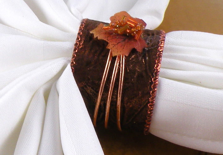 Bronze napkin ring accented with a copper leaf and beads