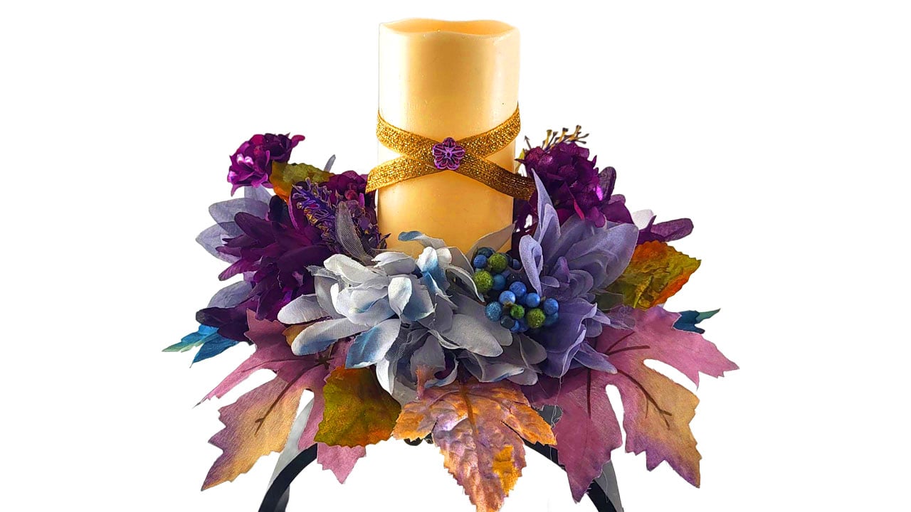 Dollar Tree flameless candle decorated with ribbon and a craft embellishment.