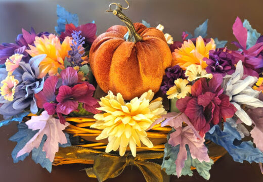 A classic orange DIY velvet pumpkin centerpiece, perfect for a Thanksgiving table.