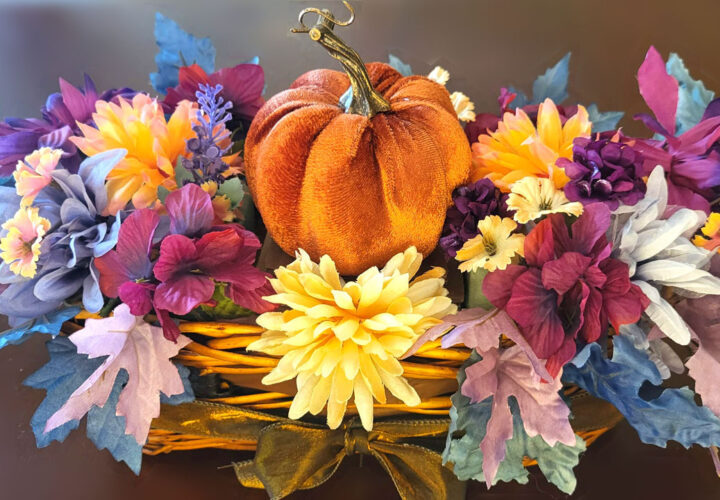 A classic orange DIY velvet pumpkin centerpiece, perfect for a Thanksgiving table.