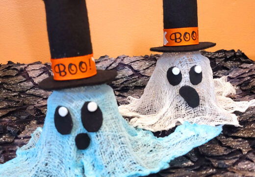 super cute small glowing ghosts with a top had, halloween ribbon around the brim, big oval eyes with an eye shine and small surprised mouth.