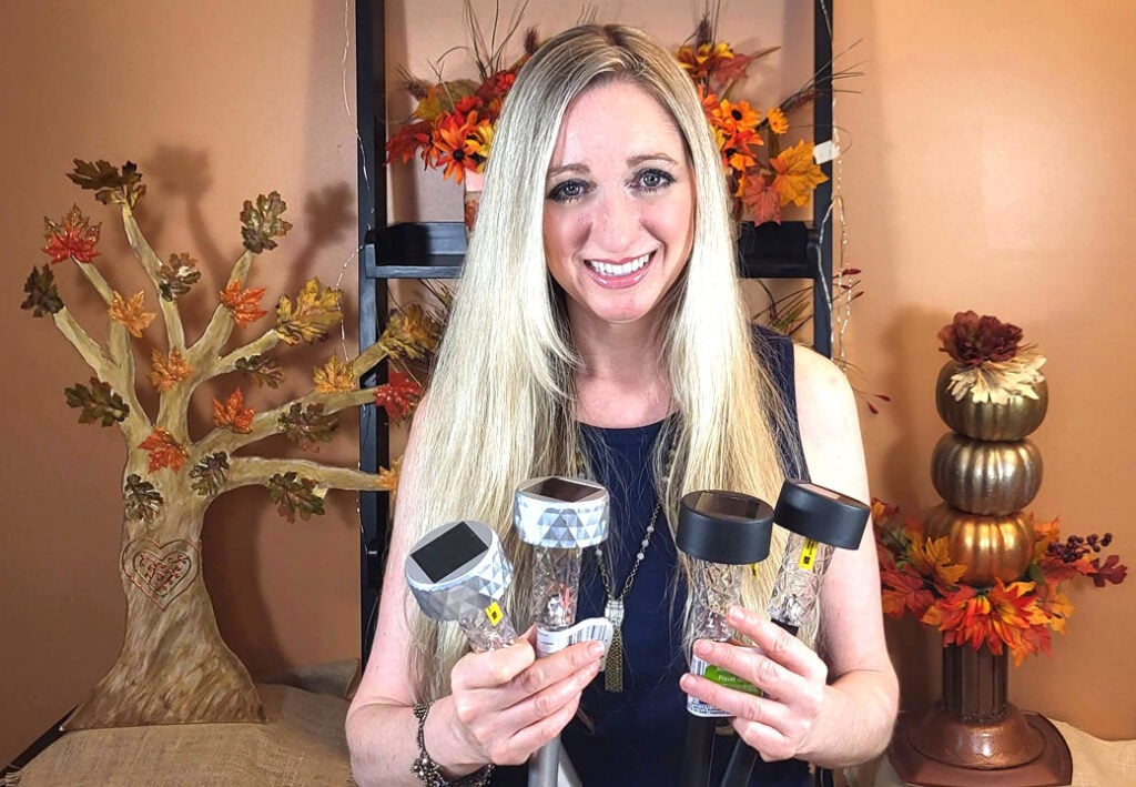 Gina Tepper holding Dollar Tree solar lights for fall DIY projects