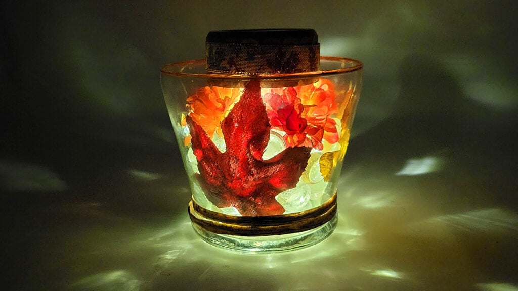 See how a Dollar Tree solar light transforms this clear gem fall lantern at night. The colorful fall leaves and gems glow beautifully, creating a warm and magical autumn decoration.