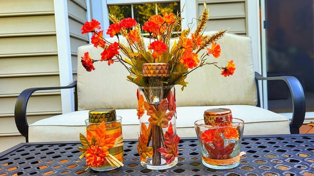 Three DIY Dollar Tree solar light fall decorations displayed together on an outdoor table
