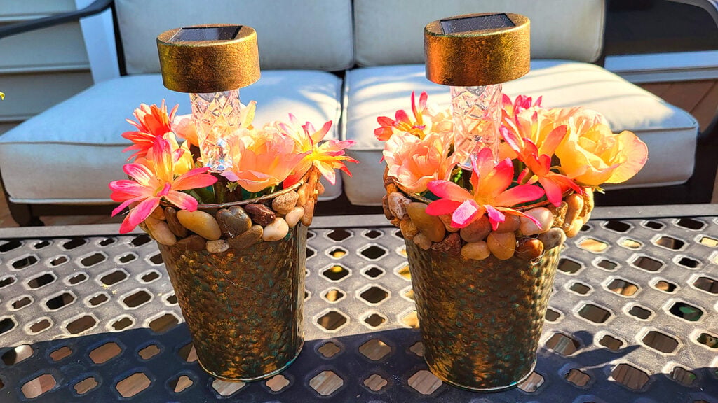 Fall candle centerpieces made with metallic vases, autumn flowers, and clear candle holders, styled as cozy Dollar Tree fall decor.