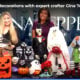 Gina Tepper and a WBAL-TV host standing behind a display of DIY Halloween decorations, including a flaming pumpkin, a haunted house, skeletons, a ghost, and other spooky crafts.